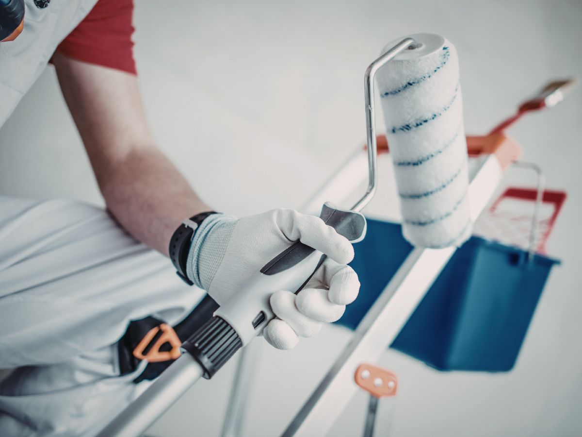 man holding painting materials