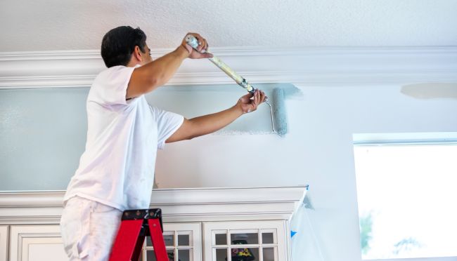 man painting the ceiling